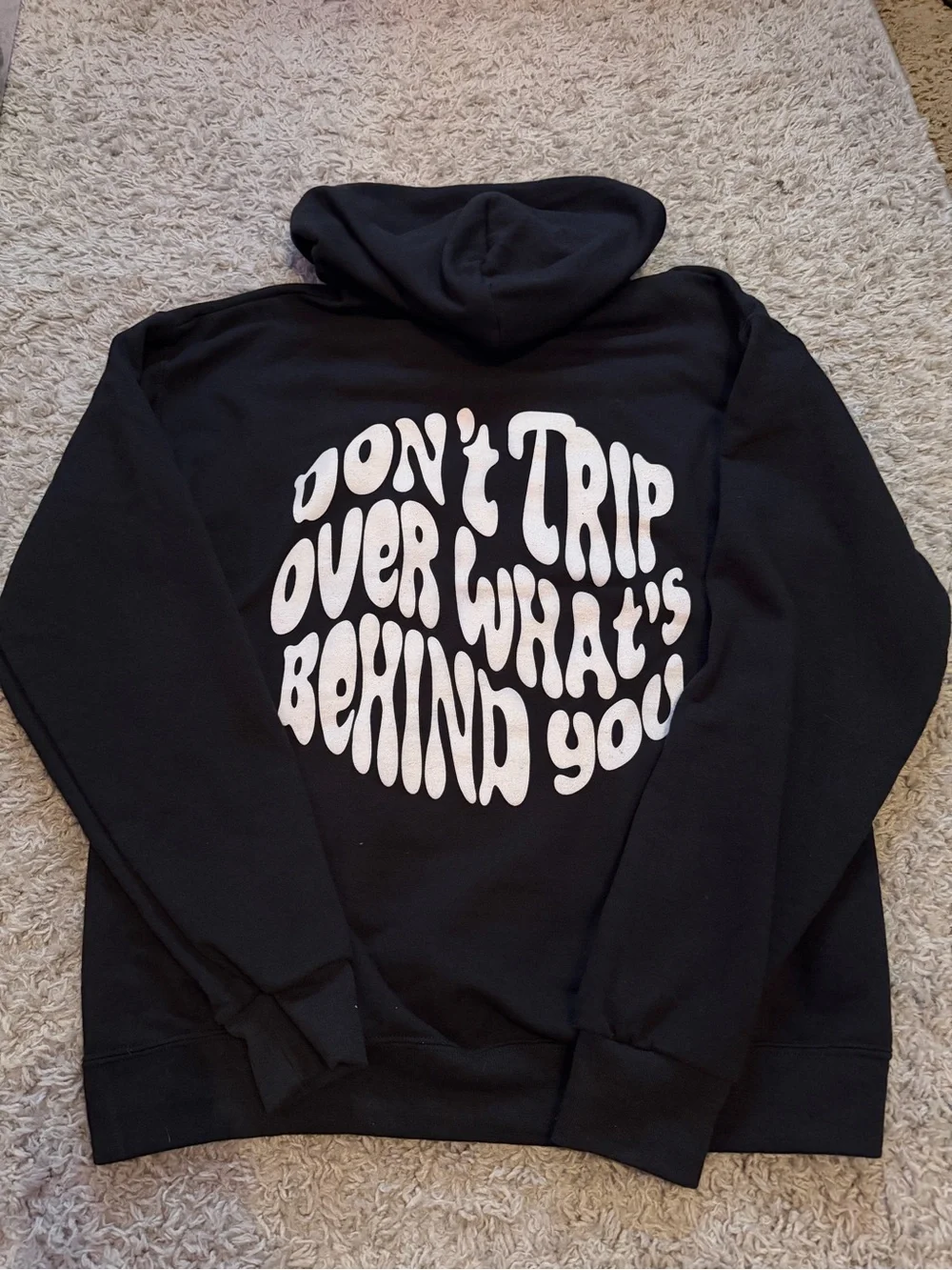 Jerzees Black Hoodie with White 'Don't Trip Over What's Behind You' Graphic